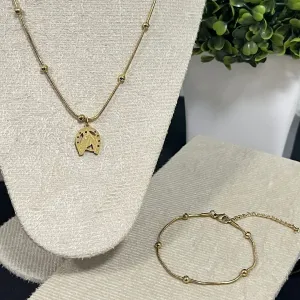 Pulseira com esferas no aço dourado