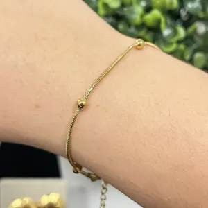Pulseira com esferas no aço dourado