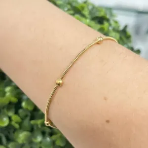 Pulseira com esferas no aço dourado