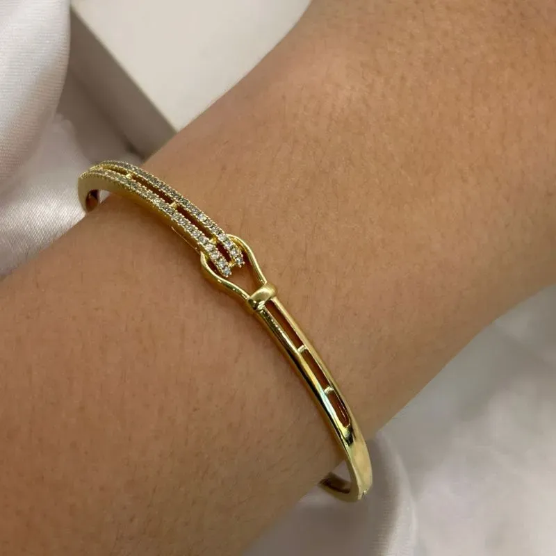 Bracelete dourado com pedras cravejadas