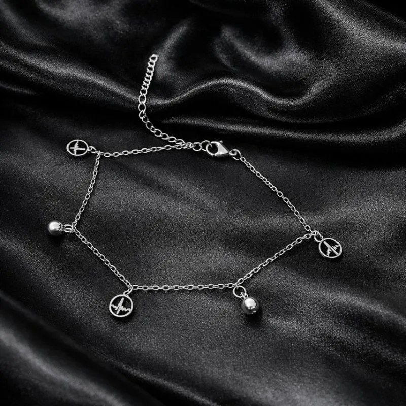 Tornozeleira de aço com pingente